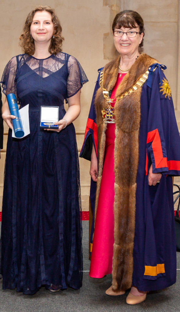 Alexandra Keeler receiving her award from Master Engineer, Aurey Canning.